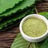 a bowl of green kratom powder
