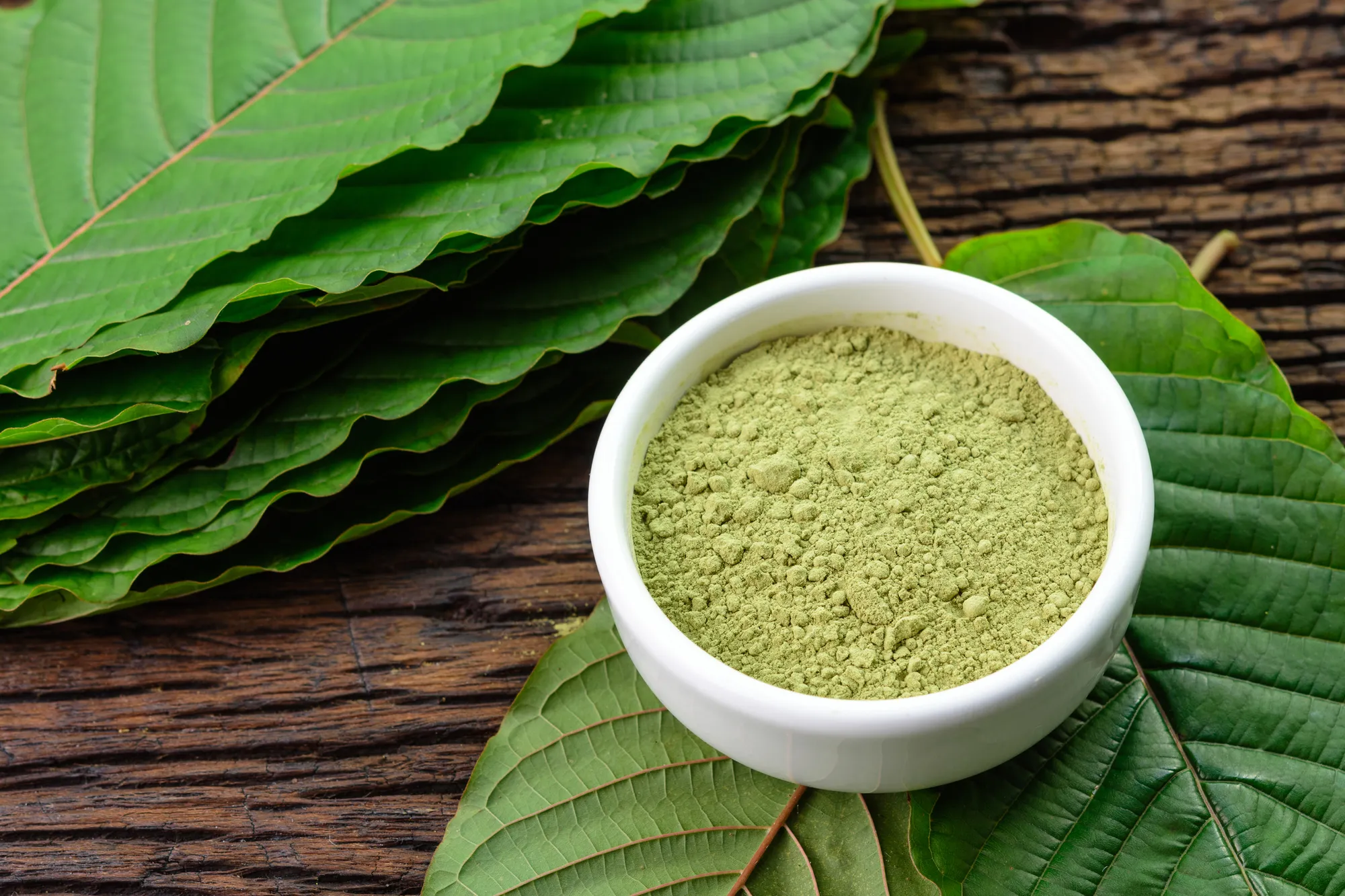 a bowl of green kratom powder
